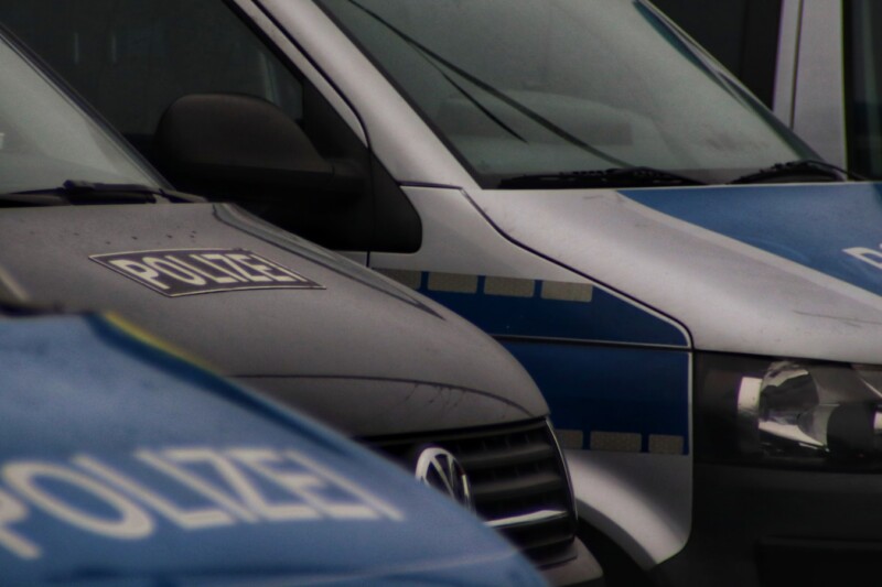 a row of police vans parked next to each other