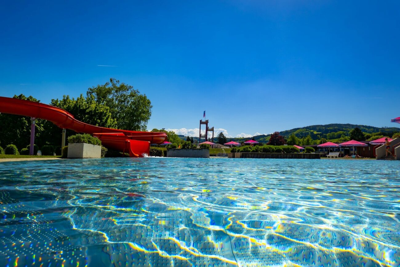 A bright and inviting pool with a waterslide