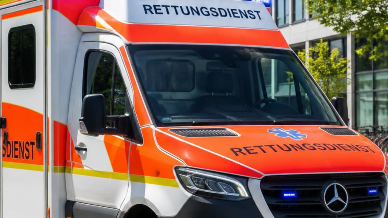 Ein Rettungswagen in der Farbe orange und weiß. Großer Schriftzug auf der Motorhaube mit dem Wort Rettungsdienst,